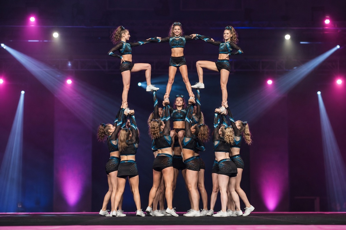 Cheerleading team performing a pyramid stunt at a competition